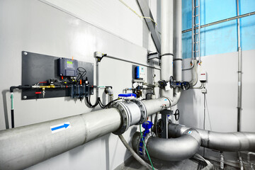 Large blue tanks in a industrial city water treatment boiler room. Wide angle perspective. Special...