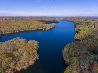 Fototapeta premium Ashland Reservoir aerial view with fall foliage in Ashland State Park in town of Ashland, Massachusetts MA, USA. 