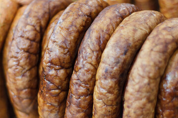 Heap of fresh prepared smoked sausage with spices