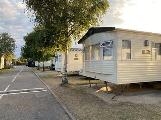 UK Holiday Park on the England East Coast, traditional United Kingdom holiday park with caravans and bungalows houses in a sunny summer day at dusk
