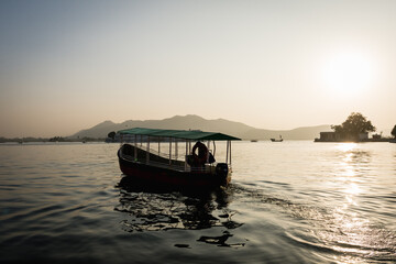 Boat on Lake Pichola at sunset in Udaiur, India