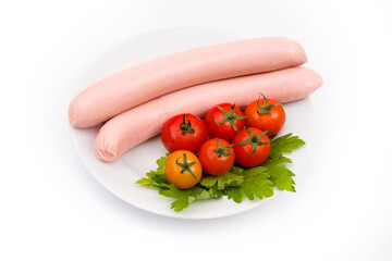 Milk sausages with cherry tomatoes and parsley on a white plate isolated on a white background