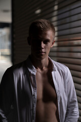 Fototapeta premium portrait of a blond, athletic guy who just turned eighteen