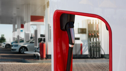 Charging station for electric vehicles in the background of a gas station