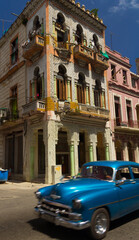 Cuban car with a building in the background in the city of la Havana, Cuba