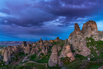Limestone rock formations under dramatic storm clouds, in Cappadocia, Turkey