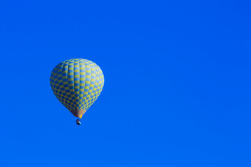 Hot air balloons profiled on clear blue sky, in Cappadocia, Turkey