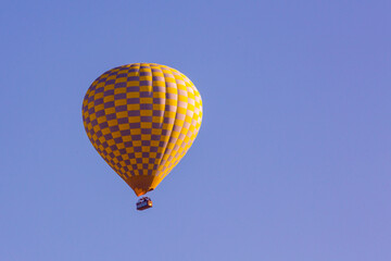 Hot air balloons profiled on clear blue sky, in Cappadocia, Turkey