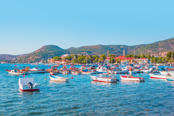 Fototapeta na wymiar Many boats in the marina with coastline of resort town of Foca - Izmir, Turkey