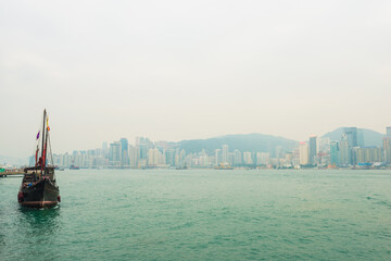 Fototapeta premium Hong Kong victoria harbour with tourist junk red flag boat