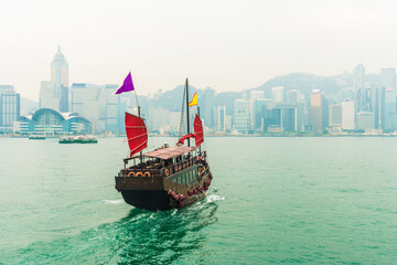 Hong Kong victoria harbour with tourist junk red flag boat