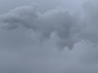 Puffs of gray smoke in the sky as a background. The sky is overcast.