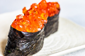 Sushi Set sashimi and sushi rolls served on stone slate