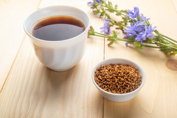 Chicory flowers, sublimated root of chicory  and chicory drink on wooden table