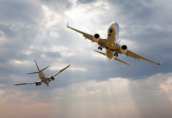 Two comerical passenger airplanes in the sky with busy air traffic - Airplane taking off from the airport