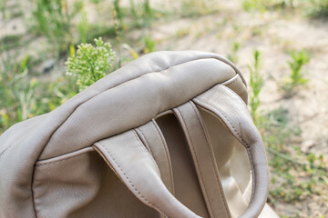 part of the backpack with harnesses and handles on the background of nature at the bottom of the...