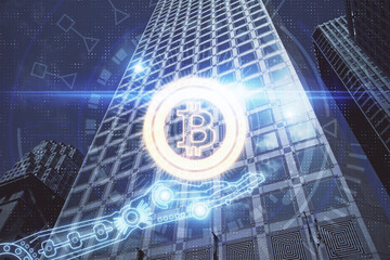 Double exposure of crypto currency theme hologram drawing and city veiw background. Concept of blockchain and bitcoin.