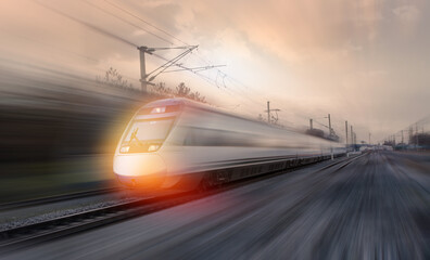 Plakat High speed train runs on rail tracks . Train in motion