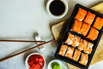Sushi Set sashimi and sushi rolls served on stone slate