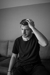 Black and White, Headache for the Holidays, Young mean looking worried holding his hands on his head