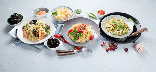 Plates of pastas with different kinds of sauces.