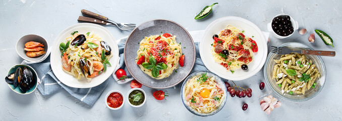 Plates of pastas with different kinds of sauces.