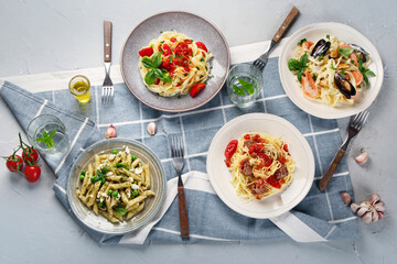 Plates of pastas with different kinds of sauces.