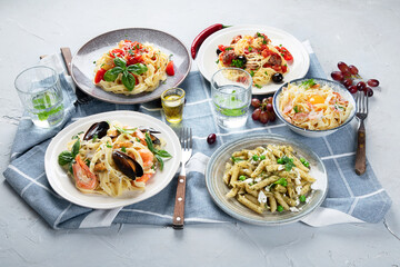 Plates of pastas with different kinds of sauces.