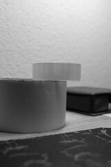 Painting tape and scotch tape placed on a table one on another AM