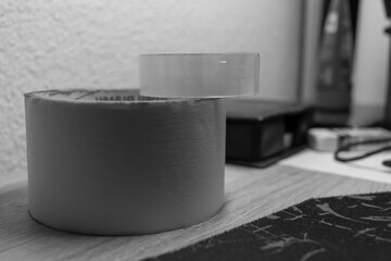 Painting tape and scotch tape placed on a table one on another AM