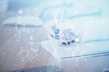 DNA theme hologram over woman's hands writing background. Concept of education. Double exposure