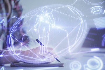 Naklejka premium Education theme hologram over woman's hands writing background. Concept of study. Double exposure