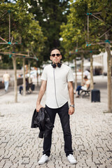 Fototapeta premium Smiling man with headphone in his neck, look in camera
