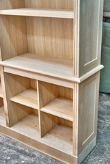 Fototapeta na wymiar Modern joinery. Wooden bookcases in process of production in workshop. Furniture manufacture