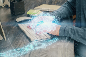 Fototapeta premium Double exposure of technology hologram with man working on computer background. Concept of big data.