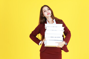 Businesswoman in red suit hand holding document books isolated on yellow background. Copy Space