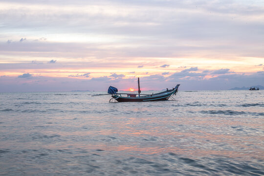 fishing boat at sunset on the ocean