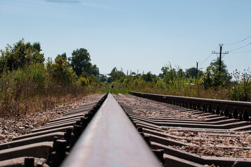 Fototapeta na wymiar Railway tracks and gravel leading into the infinite distance