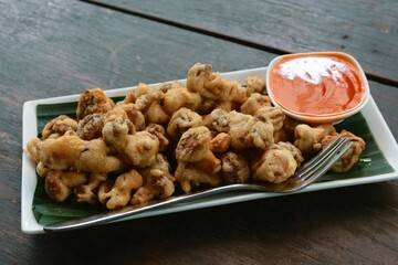 stir fried mushroom with chili sauce on wood table
