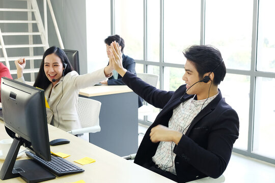Powerful and Sucessful of Business group Call Center and technical Support staff Touch hands for good job  of receptionist phone operator. Asian customer support team.
