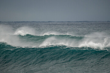 Bib waves rolling into the beach, massive surf day