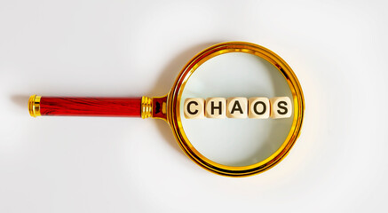 Wooden Blocks with the text: CHAOS on a magnifying glass.