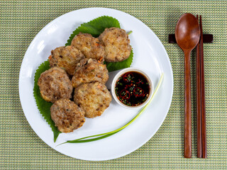 Korean food : Donjeonya(Donggeurangttaeng). A mixture of ground beef or pork and minced vegetables molded into round shapes, flour-coated, egg-battered, and pan-fried.