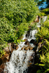 Waterfall in the park at sunny summer day