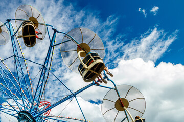 Ride carousel in motion in amusement park at sunny day