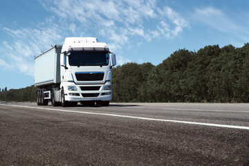 truck on the road, front view, empty space on a white container - concept of cargo transportation,...