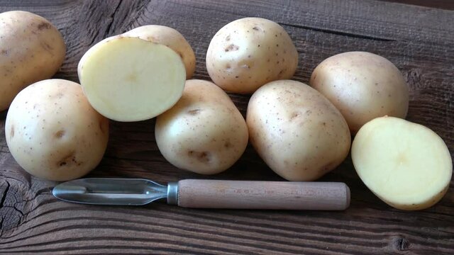 Potatoes on the wood board. Fresh potato on rustic background

