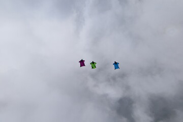 Skydivers over snowy mountains in Norway