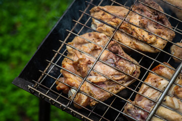 Chicken meat grilling on the brazier. Selective focus. 
