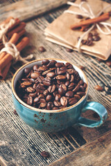 Cup full of coffee beans on wooden table